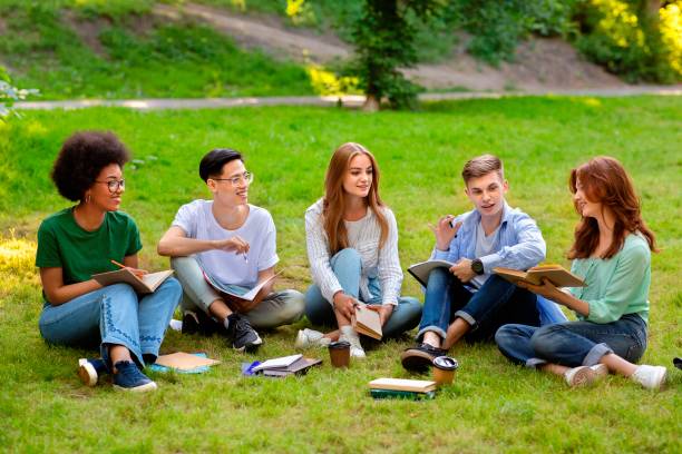 istock Students Leisure. Group of multiethnic college friends studying together outdoors at campus 1265951306