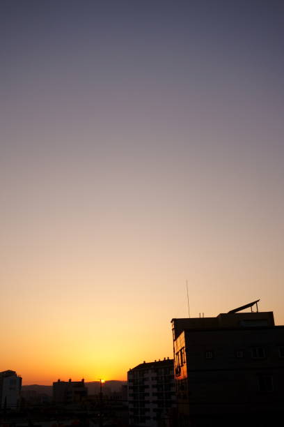 istock Silhouettes of Buildings against Sunset 1265953998