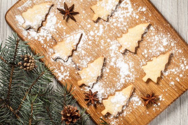 istock Gingerbread cookies in Christmas tree shape on wooden cutting board 1265955073