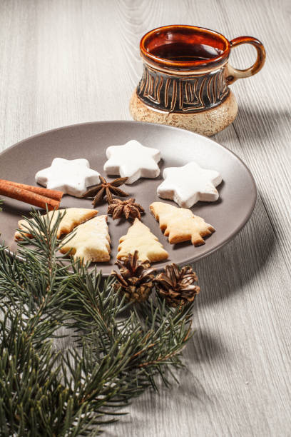 istock Gingerbread cookies in Christmas tree and star shape on plate with cup of coffee 1265956169