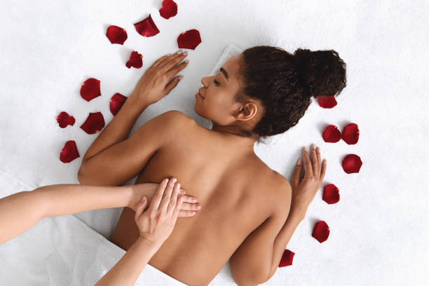 istock African girl getting healing back massage at spa 1265957747