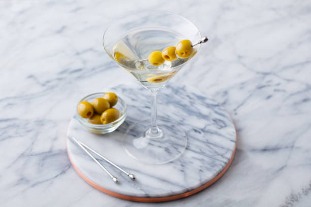 istock Martini cocktail with olives on marble table background. Close up. 1265957764