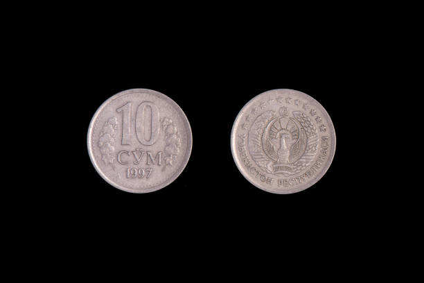 istock 10 Uzbek som coin on a black background. close-up on both sides 1265957928