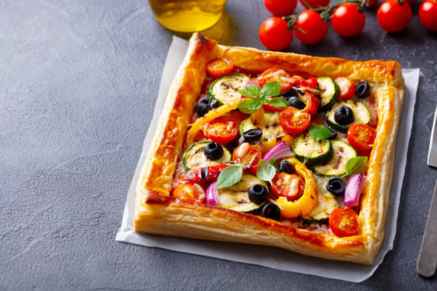 istock Puff pastry pizza with grilled vegetables. Grey background. Close up. 1265958407