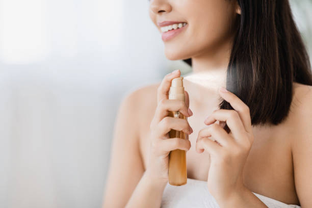 Closeup of asian girl using hair spray, copy space Hair products. Closeup of unrecognizable asian girl using hair spray, copy space serum sample stock pictures, royalty-free photos & images