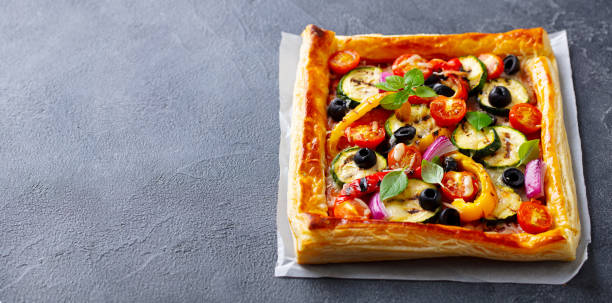 istock Puff pastry pizza with grilled vegetables. Grey background. Copy space. Close up. 1265962946
