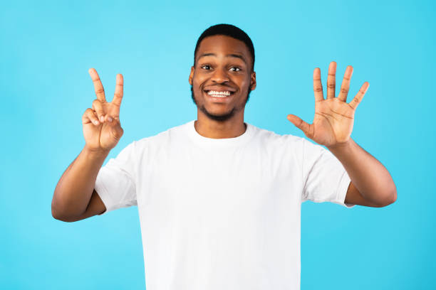 istock Black Man Showing Number Seven Smiling To Camera, Blue Background 1265964818