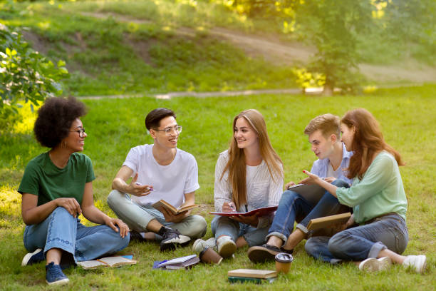 istock Happy multiracial students resting and preparing for exams outdoors at campus 1265971970