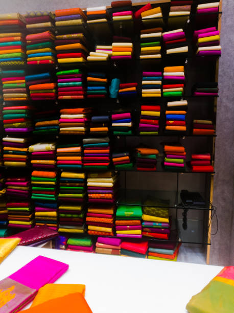 istock A Huge collections of different colored sarees and materials placed in a shelf. 1265972256