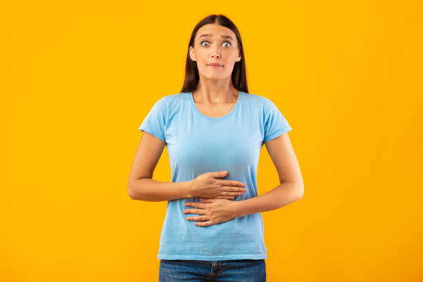 istock Young female model touching her stomach at studio 1265972377