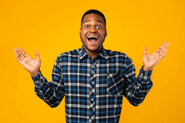 istock Surprised African Guy Posing With Opened Mouth Over Yellow Background 1265972663