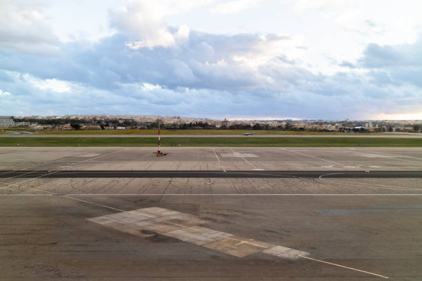 istock Runway at the Airport on a Cloudy Day 1265972728