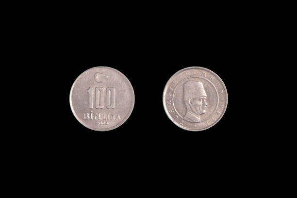 istock Turkish 100 Bin Liras Coins Isolated On black. close-up. 1265983651