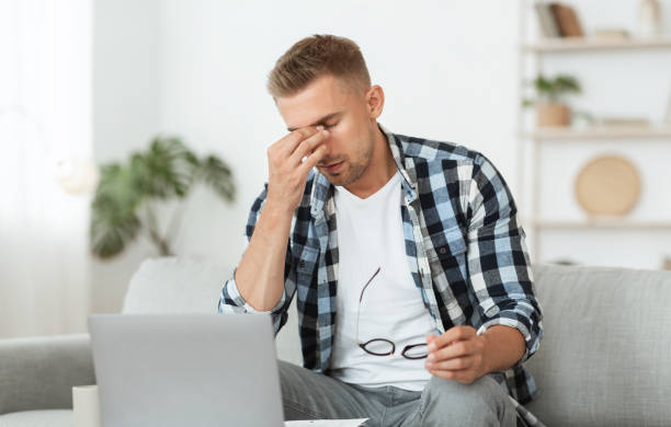 istock Tired american manager using his pc at home 1265984712