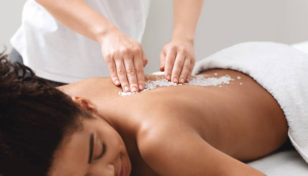 istock African american lady getting salt massage at modern spa 1265988542