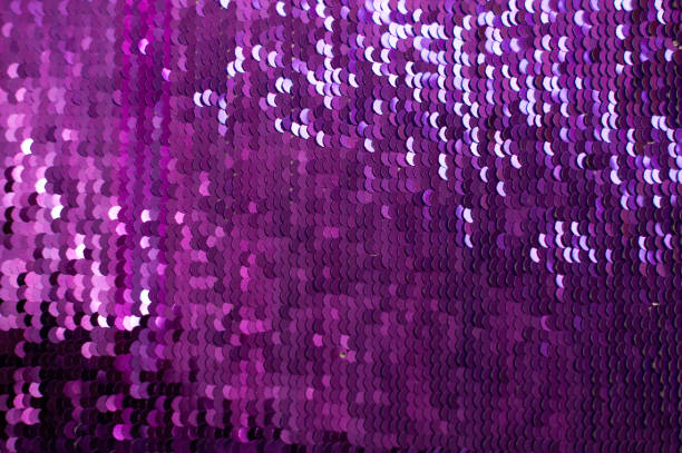lilac Background with Sequins close-up. Abstract Texture scales with shiny sequins on fabric.