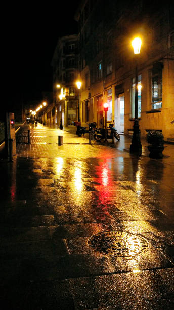 istock Rainy night street view, colorful traffic lights and reflections. 1266003510