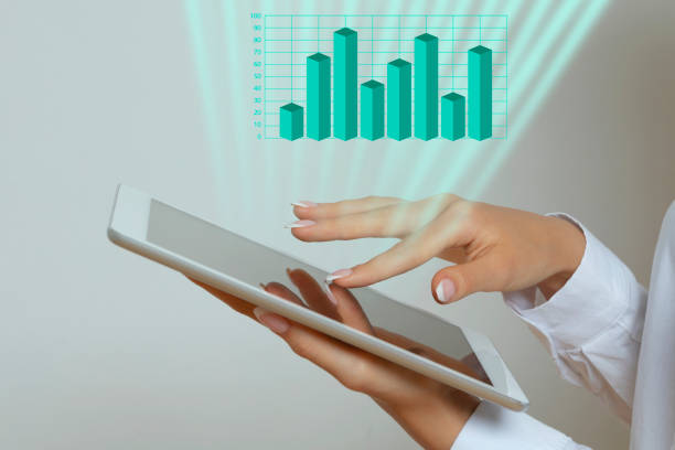 istock Woman holding digital tablet with success graph 1266010086