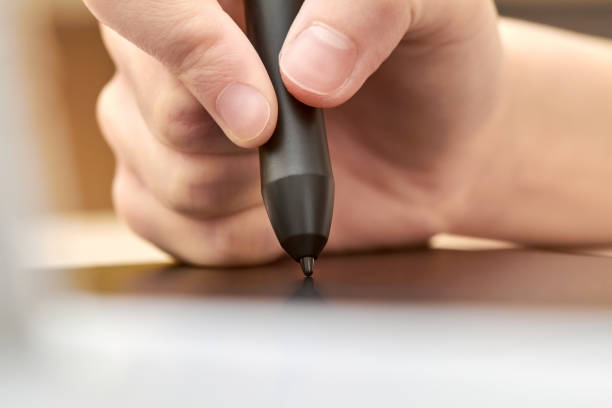 istock Girl draws on a graphics tablet with pen. Close-up, selective focus 1266010545