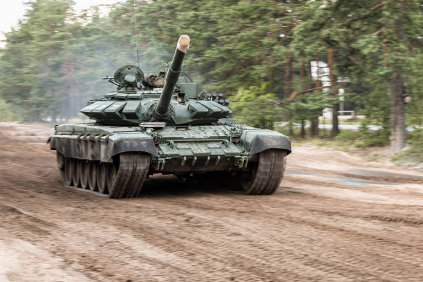 istock battle tank drives along a country road through a forest 1266016041