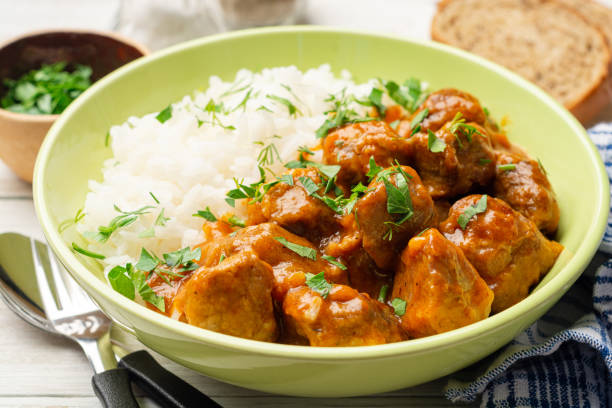 istock Meat stew with white rice on rustic wooden background 1266020596