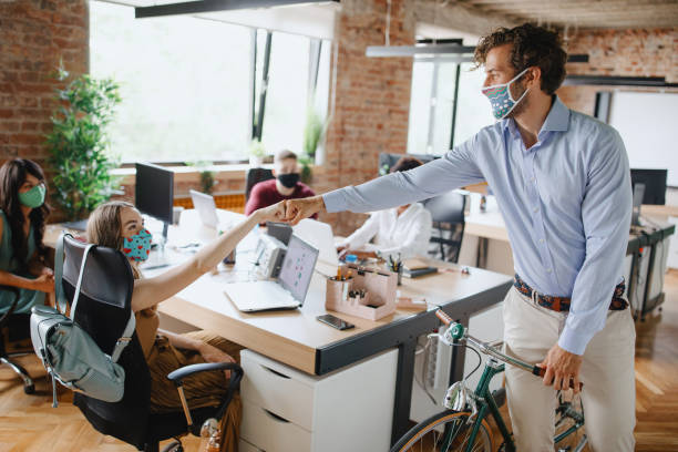istock Colleagues greeting with fist bump in office 1266022446