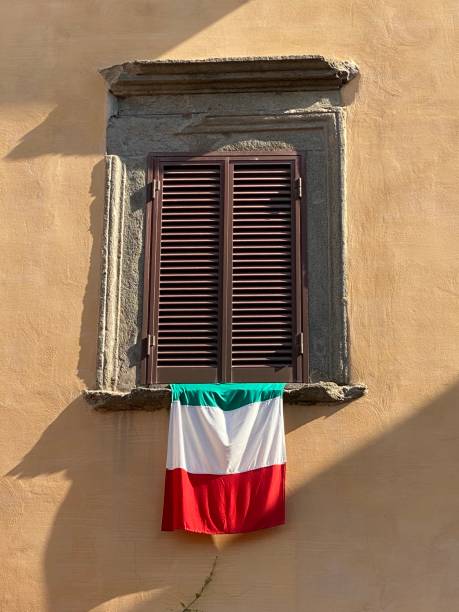istock Italian flag hanging from old window 1266022751