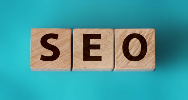 istock SEO word on wooden blocks with letters, search engine optimization SEO business concept, top view on aquamarine cyan background 1266022880