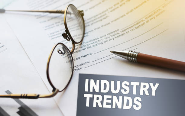 istock Iindustry trends text on a card. Agreement with pen and glasses. Selective focus. Business work office career concept 1266022901