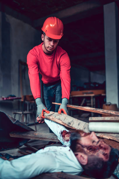 istock Emergency Worker Lifting Debris To Save Injured Male 1266025199