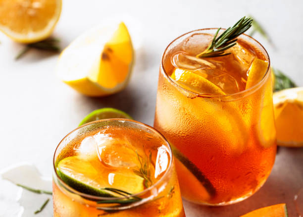 istock Iced tea with lemon, lime and ice garnished with rosemary twigs. 1266029436