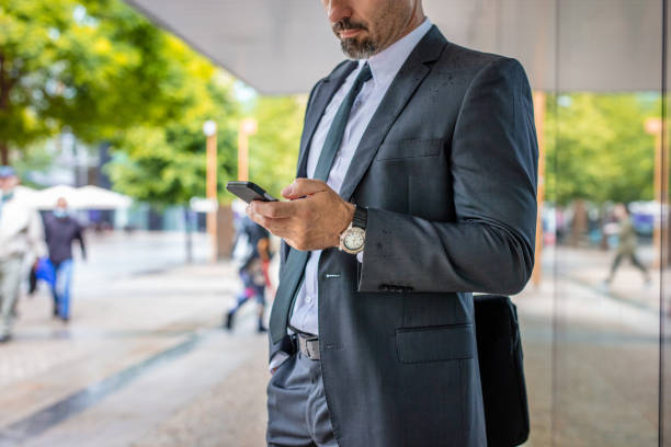 istock Businessman typing on his phone 1266029557