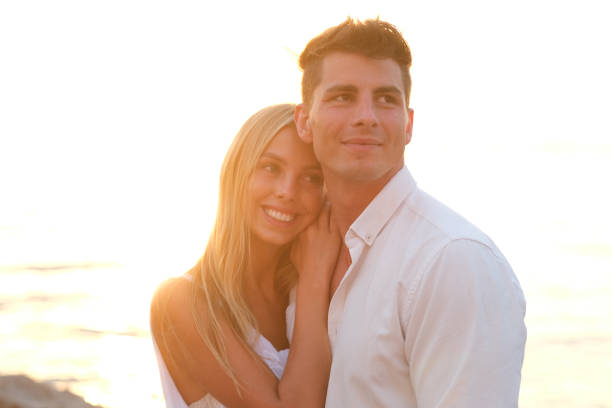 istock Happy couple watching the sunset. 1266029862