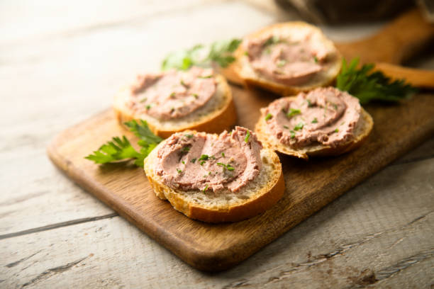 Pate Traditional homemade pate on a white bread crostini stock pictures, royalty-free photos & images