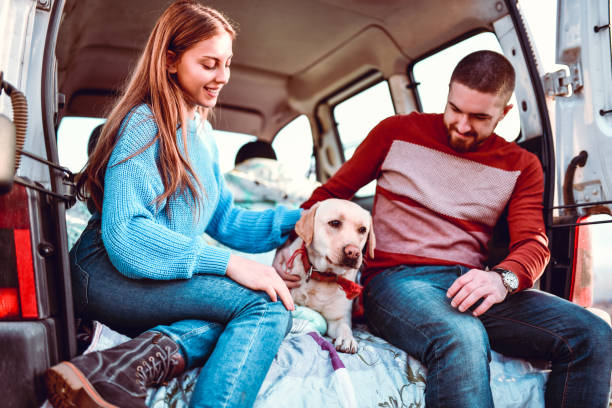 istock Couple Enjoying Road Trip With Cute Dog 1266031356
