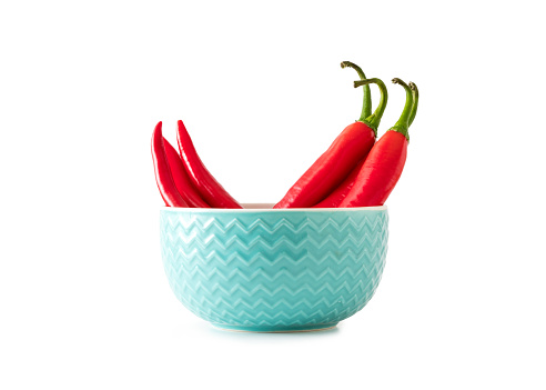 Red chilli pepper in blue bowl.