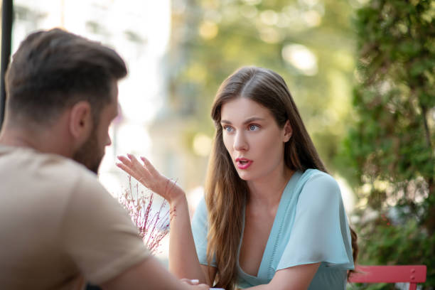 istock Sad couple sitting in open air cafe, arguing with each other 1266032059