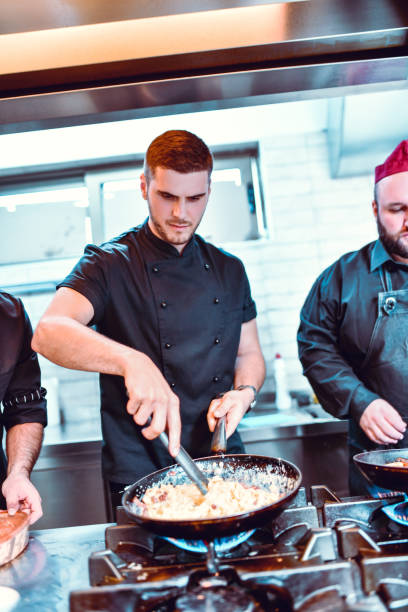 istock Male Chefs Working On New Dish In Restaurant Kitchen 1266036851