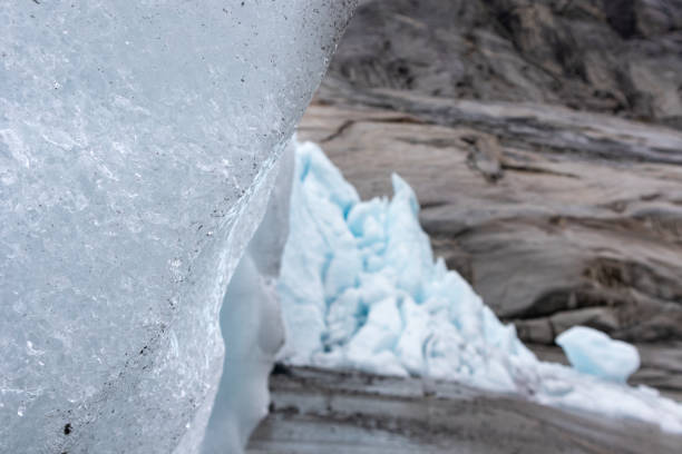 Nigardsbreen glacier ice and snow close view in Jostedalsbreen national park. Norway mountains landscape view with deep color blue ice, rocks, snow. Climate change, melting glacier
