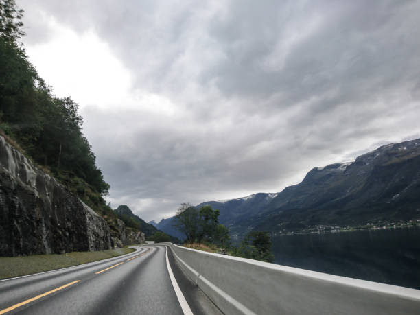 istock Drive Norway asphalt road on greyday 1266037566