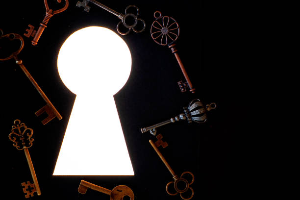istock Many different antique keys and a keyhole. Finding the right key to the lock, concept. 1266044665