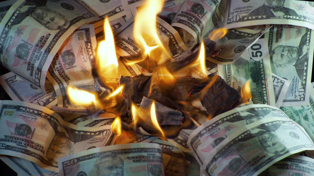 A lot of dollars in the fire, the global financial crisis and inflation, the concept stock photo