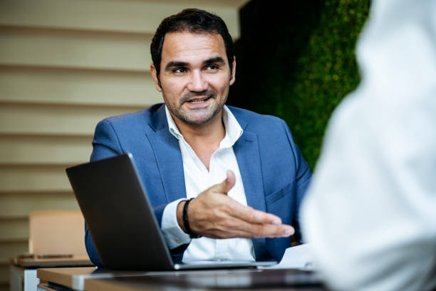 istock Confident Hispanic businessman making persuasive sales pitch 1266054757
