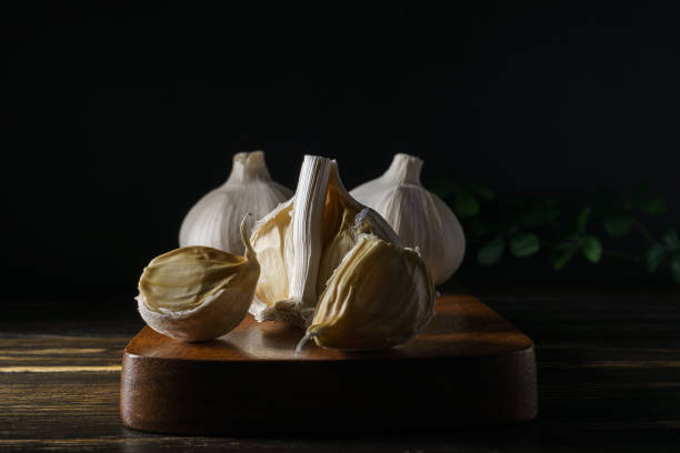 istock Fresh garlic on wooden background 1266059673