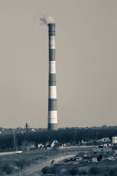 Greyscale energy heat power station pipe with stripes. Europe, Ukraine industrial sky landscape with air pollution smoke tower.