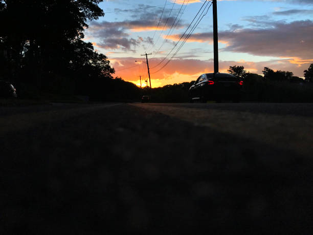 istock Colorful Sunset Sky with Road and Car 1266062279