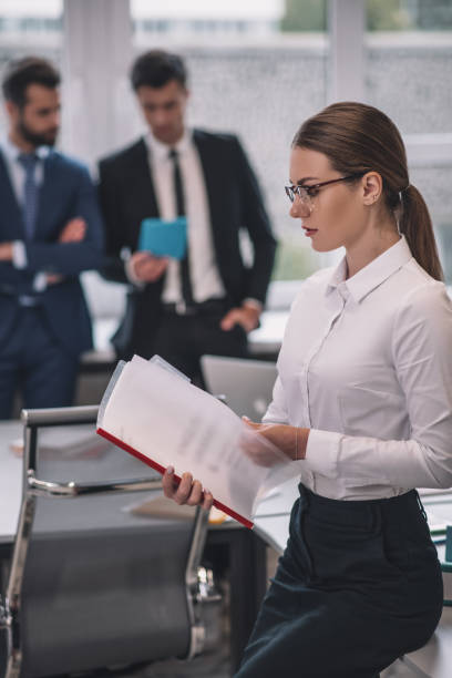 istock Attentive woman in profile looking at documents 1266062305