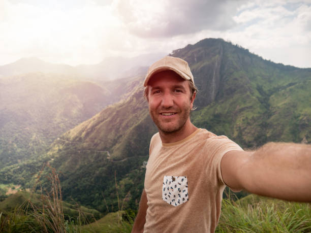 istock Man takes selfie photo on mountain top 1266062981