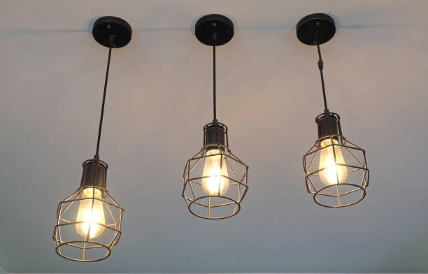 istock Vintage, modern hanging 3 light bulb over gray background. Interior design. 1266067022