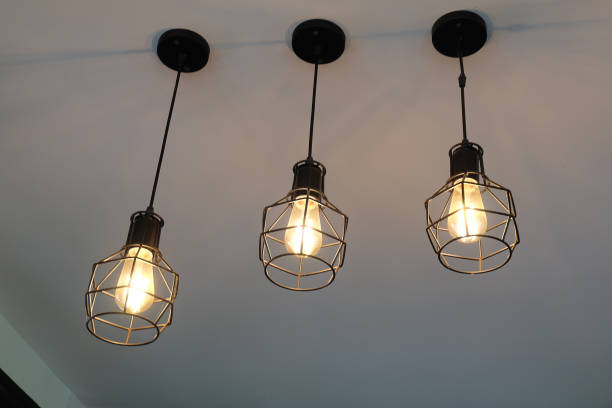 istock Vintage, modern hanging 3 light bulb over gray background. Interior design. 1266067138